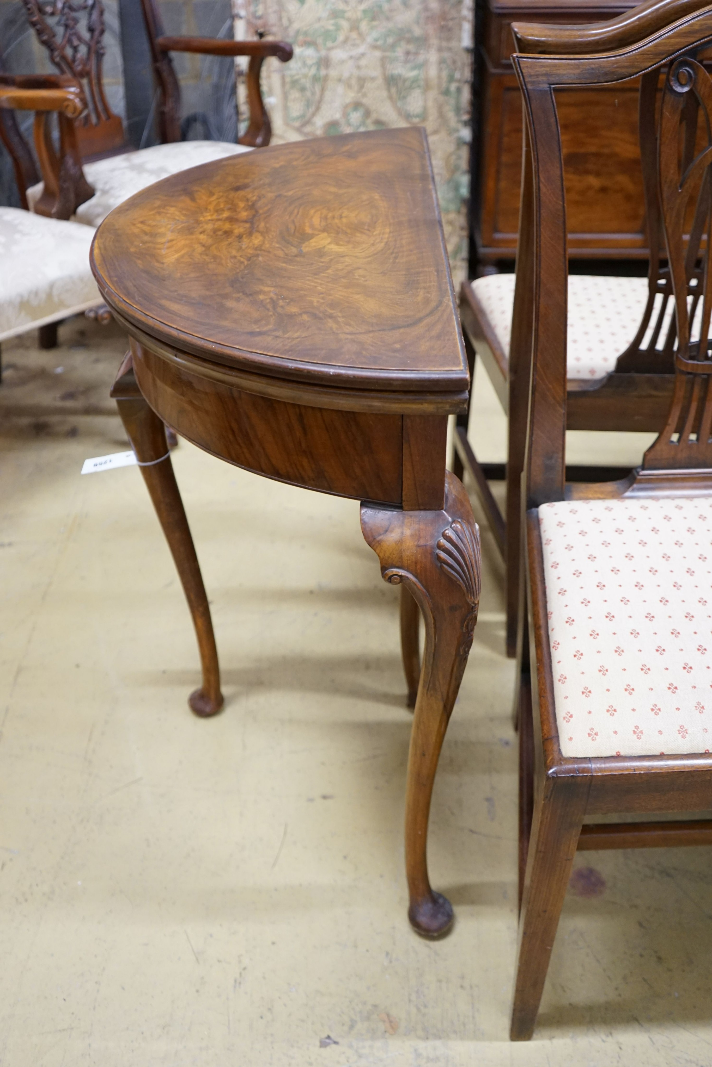 A Queen Anne revival walnut demi-lune folding card table, width 76cm, depth 38cm, height 76cm